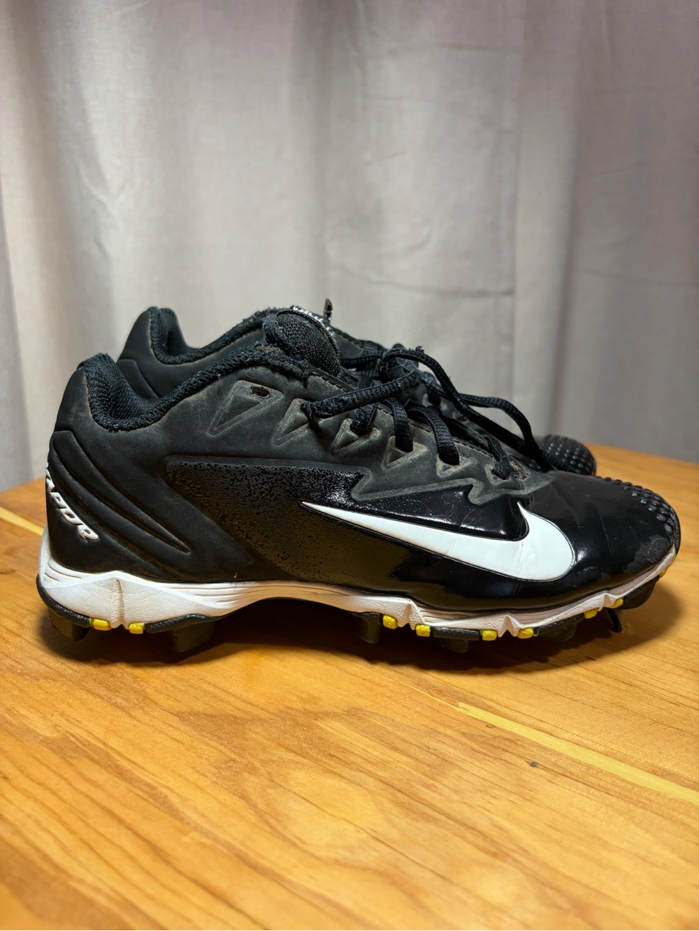 Nike Black and White Baseball Cleats with Yellow Stud Accents